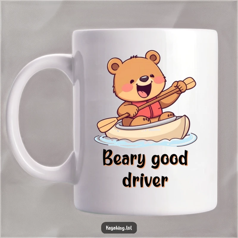 Funny mug showing an excited bear comically trying to steer a kayak with a paddle, full of determination and clumsy energy.