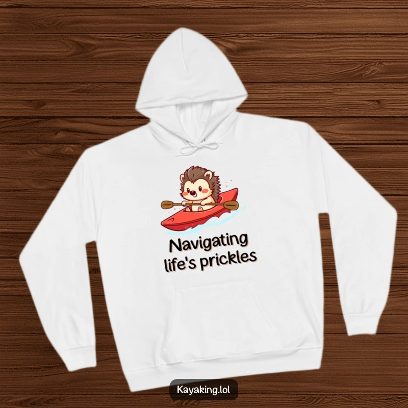 Funny hoodie with a smiling hedgehog steering a bright red kayak, offering comfort and a touch of whimsical water adventure.