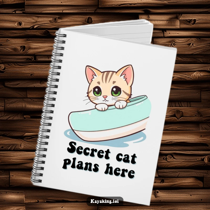 Funny cat peeking from a kayak, featured on a notebook cover for jotting down curious thoughts and ideas.