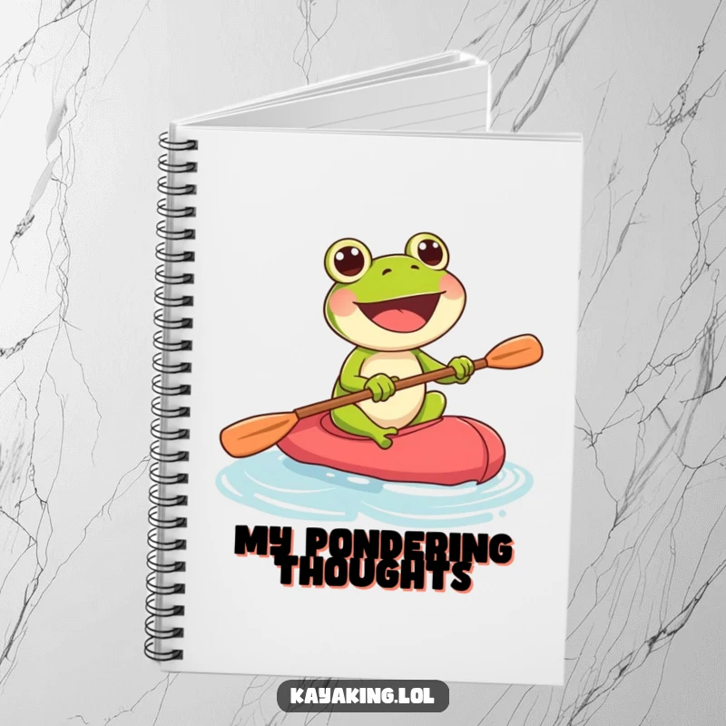 Funny frog paddling with vigor in a kayak, featured on a notebook cover for capturing energetic thoughts.