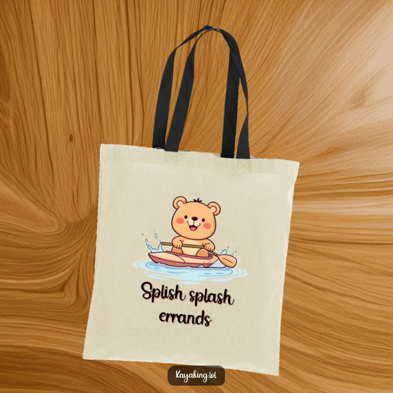 Funny bear happily kayaking and splashing water with a paddle, on a tote bag, perfect for eco-conscious adventurers.